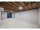 Spacious unfinished basement with cement block walls and painted floor at 4509 Alamance Baptist Church Loop, Burlington, NC 27215