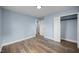 Open bedroom showcasing wood-look floors, closet space, and neutral paint at 4509 Alamance Baptist Church Loop, Burlington, NC 27215