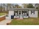 Charming home exterior featuring a covered front porch and renovated facade at 4509 Alamance Baptist Church Loop, Burlington, NC 27215