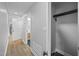 Hallway view with modern light fixtures, closet with black hardware and neutral paint scheme at 4509 Alamance Baptist Church Loop, Burlington, NC 27215