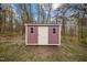 Exterior of a storage shed with a wooden door and windows at 4509 Alamance Baptist Church Loop, Burlington, NC 27215
