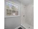 The shower area features elegant marble tiling, a modern showerhead, and a built-in bench at 4509 Alamance Baptist Church Loop, Burlington, NC 27215