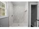 Walk-in shower featuring marble tiling, a modern showerhead, and built-in niche for storage at 4509 Alamance Baptist Church Loop, Burlington, NC 27215