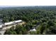 Aerial image displays the house set amongst a heavily wooded area at 5107 Hearth Dr, Raleigh, NC 27609