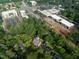 Aerial view of a new construction home in a neighborhood surrounded by tall trees and a shopping center at 5107 Hearth Dr, Raleigh, NC 27609