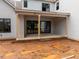 Covered back patio that has exposed wood support beams and a brick base on a muddy lot at 5107 Hearth Dr, Raleigh, NC 27609
