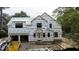 Exterior elevation featuring new house construction, a modern design, and a brick foundation at 5107 Hearth Dr, Raleigh, NC 27609