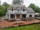 New construction shows a two-story home with brick base and ladder access points on a muddy lot at 5107 Hearth Dr, Raleigh, NC 27609