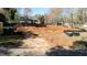 Homesite ready for new construction with dirt and grass and some surrounding trees at 5107 Hearth Dr, Raleigh, NC 27609