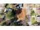 Aerial view of a new construction homesite with building pad completed in a wooded neighborhood at 5107 Hearth Dr, Raleigh, NC 27609