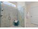 Walk-in shower featuring a glass door, rain shower head, and marble tiling at 5205 Sorrell Glen Dr, Raleigh, NC 27603