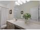Bathroom vanity with double sinks, quartz countertop, and modern fixtures at 5205 Sorrell Glen Dr, Raleigh, NC 27603