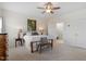 Cozy bedroom with a ceiling fan, comfortable bed, and view into the ensuite bathroom at 5205 Sorrell Glen Dr, Raleigh, NC 27603