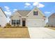 Charming single-Gathering home with a well-manicured lawn, two-car garage, and neutral siding at 5205 Sorrell Glen Dr, Raleigh, NC 27603
