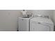 Bright laundry room with modern, white, matching washer and dryer units at 5205 Sorrell Glen Dr, Raleigh, NC 27603
