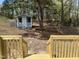 Charming backyard shed with access from new wood deck with stairs and wooden railing at 5486 B Us Hwy 301, Four Oaks, NC 27524