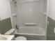 Bathroom with shower-tub combo, toilet, and vintage tiled walls at 5486 B Us Hwy 301, Four Oaks, NC 27524