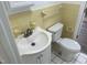 Cozy bathroom featuring a white sink, toilet, and charming yellow tiled walls at 5486 B Us Hwy 301, Four Oaks, NC 27524