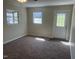 Bright bedroom featuring natural light and carpet, with access to an exterior door at 5486 B Us Hwy 301, Four Oaks, NC 27524