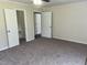 Inviting bedroom offers neutral walls and carpet, with closet space for organized living at 5486 B Us Hwy 301, Four Oaks, NC 27524