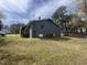 View of side of gray home with A/C unit, partial porch and metal fencing at 5486 B Us Hwy 301, Four Oaks, NC 27524