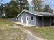 Gray home with white trim, double doors, concrete foundation and front yard at 5486 B Us Hwy 301, Four Oaks, NC 27524