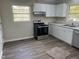 This kitchen features stainless appliances, granite countertops, and bright white cabinetry at 5486 B Us Hwy 301, Four Oaks, NC 27524