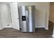 A stainless steel refrigerator stands adjacent to a bathroom in this home at 5486 B Us Hwy 301, Four Oaks, NC 27524