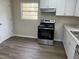 Kitchen featuring modern appliances, new countertops, updated cabinets, and wood flooring at 5486 B Us Hwy 301, Four Oaks, NC 27524