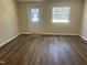 Spacious room with new floors, natural light, and an exterior door at 5486 B Us Hwy 301, Four Oaks, NC 27524