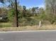 View of scenic pond surrounded by lush trees at 5486 B Us Hwy 301, Four Oaks, NC 27524