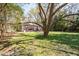 Private backyard with mature trees providing shade and tranquility; ideal for Gathering activities at 55 Lindsey St, Pittsboro, NC 27312