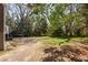 Lush backyard with mature trees offering shade and a private setting; great for relaxing at 55 Lindsey St, Pittsboro, NC 27312