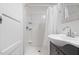 Bathroom featuring a single sink vanity, a sliding-door mirror, and a shower with white tiles at 55 Lindsey St, Pittsboro, NC 27312