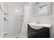 Bathroom featuring a single sink vanity, a sliding-door mirror, and a shower with white tiles at 55 Lindsey St, Pittsboro, NC 27312
