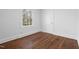 Bedroom with hardwood floors and a window, with lots of light, provides a serene space at 55 Lindsey St, Pittsboro, NC 27312