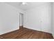 A bedroom with hardwood floors, white walls, doors, and trim provides a clean and bright space at 55 Lindsey St, Pittsboro, NC 27312