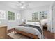 Bright bedroom features two large windows and neutral decor at 55 Lindsey St, Pittsboro, NC 27312