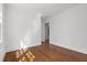 Bedroom featuring hardwood floors, white walls, and a doorway into another room at 55 Lindsey St, Pittsboro, NC 27312