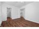 Bedroom featuring hardwood floors, white walls, and a view into a large, well-lit closet at 55 Lindsey St, Pittsboro, NC 27312