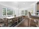 Bright dining area with large windows, a ceiling fan, and an open layout, perfect for gatherings and meals at 55 Lindsey St, Pittsboro, NC 27312