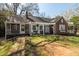 Inviting single-Gathering home with a pergola-covered porch and a lush green lawn at 55 Lindsey St, Pittsboro, NC 27312