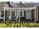 Inviting entrance showcasing a covered porch, seating, and charming architectural details for a warm welcome at 55 Lindsey St, Pittsboro, NC 27312
