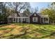 Charming home with a well-manicured lawn, inviting facade, and a cozy porch with outdoor seating at 55 Lindsey St, Pittsboro, NC 27312