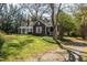 Quaint home with a welcoming front porch, mature trees, and a well-kept lawn, offering a serene retreat at 55 Lindsey St, Pittsboro, NC 27312