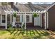 Cozy front porch with a pergola, seating, and blue shutters at 55 Lindsey St, Pittsboro, NC 27312