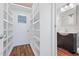 Hallway with shelves and a door leading to a bathroom with a single sink vanity at 55 Lindsey St, Pittsboro, NC 27312