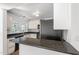 Bright kitchen featuring granite counters, modern appliances, and white cabinets at 55 Lindsey St, Pittsboro, NC 27312