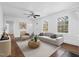 Bright, furnished living room with neutral tones, hardwood floors, and natural light at 55 Lindsey St, Pittsboro, NC 27312