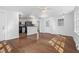 Open-concept living area with wood floors, a connecting kitchen, and a back door for seamless indoor-outdoor living at 55 Lindsey St, Pittsboro, NC 27312